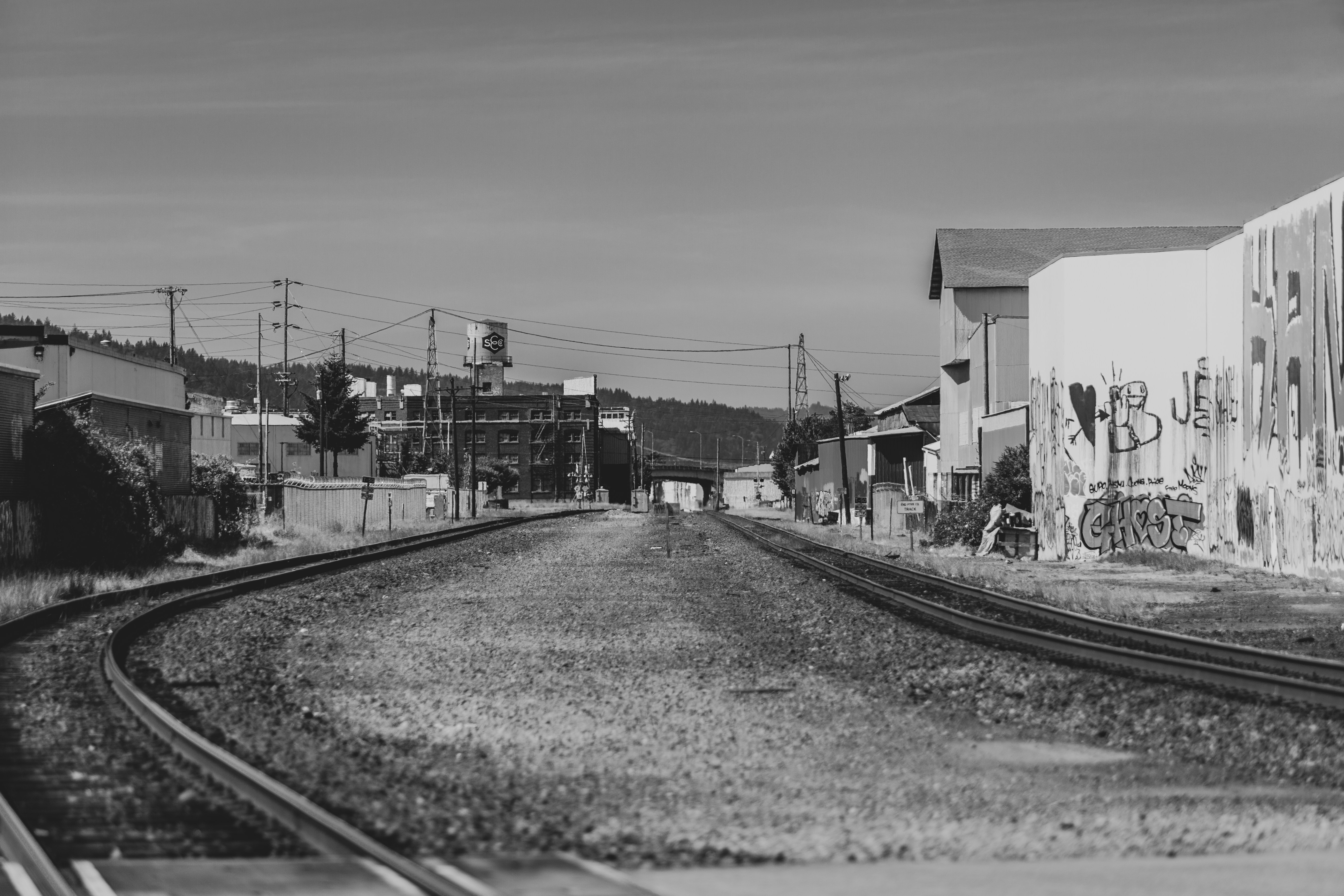 grayscale photo of train rail